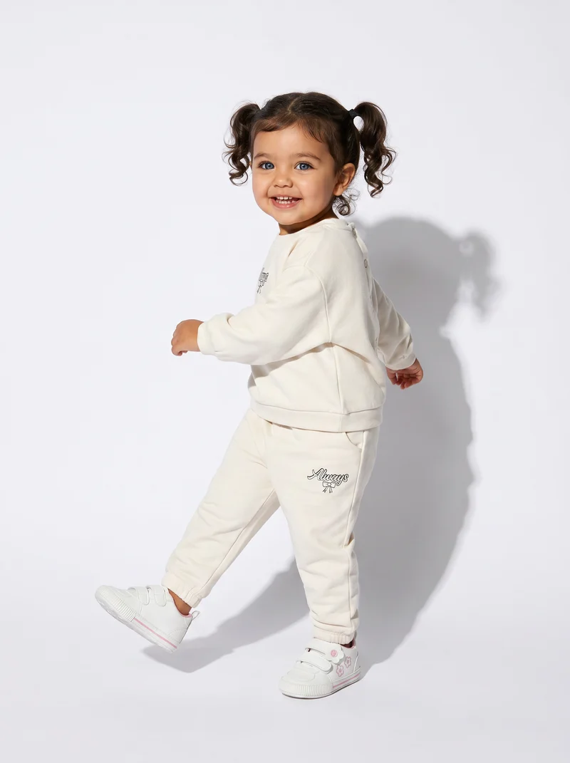 Jogger in cotone con fiocco e patch - Beige