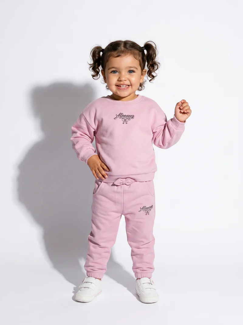 Jogger in cotone con fiocco e patch - Rosa polvere