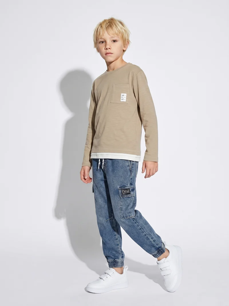 Jogging in denim con tasca laterale - Denim