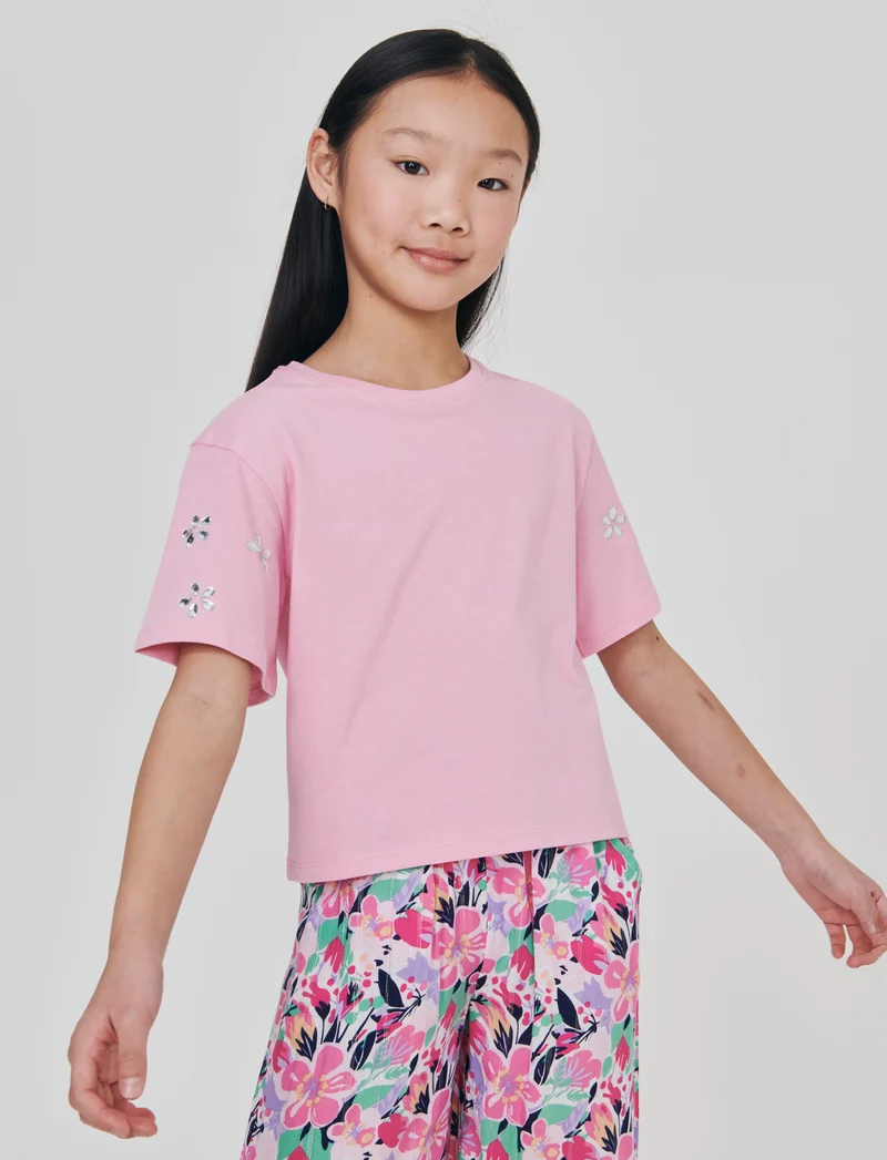 T-shirt ampia con pietre adesive e rib - Rosa